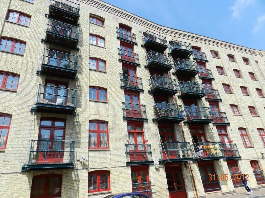 Globe Wharf Victorian warehouse facade with red-framed windows on the River Thames